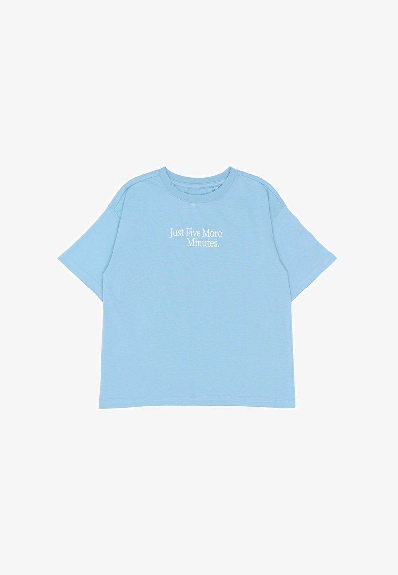 T-shirt bleu clair à manches courtes en coton doux, avec un texte blanc indiquant "Juste cinq minutes de plus". Design simple, coupe détendue.