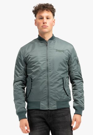 Green bomber jacket, zip closure, ribbed cuffs and hem, side pockets, textured fabric, embroidered logo on chest, smooth finish.
