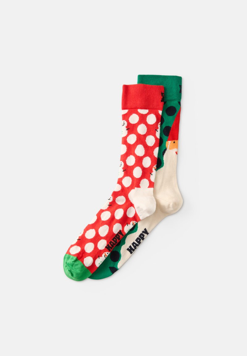 Punased ja rohelised puuvillased sokid, millel on valged laigud, lumeinimesed ja pidulik kujundus; sisaldab rohelisi varba ja sääre aktsente.