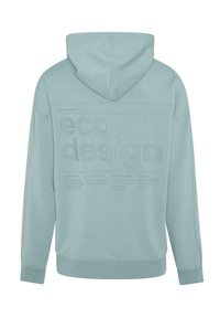 Heledas teelihaline kapuutsiga sviiter, mille seljal on reljeefne "öko disain" tekst ja täiendavad detailid jätkusuutlikkuse kohta. Pehme kangast tekstuur.