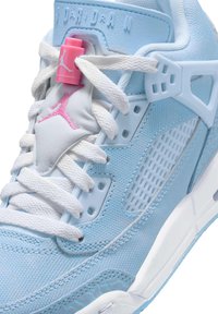 Baskets bleu clair avec un dessus texturé, des lacets blancs, des accents roses et un panneau en maille. Branding Jordan notable et éléments de design uniques.
