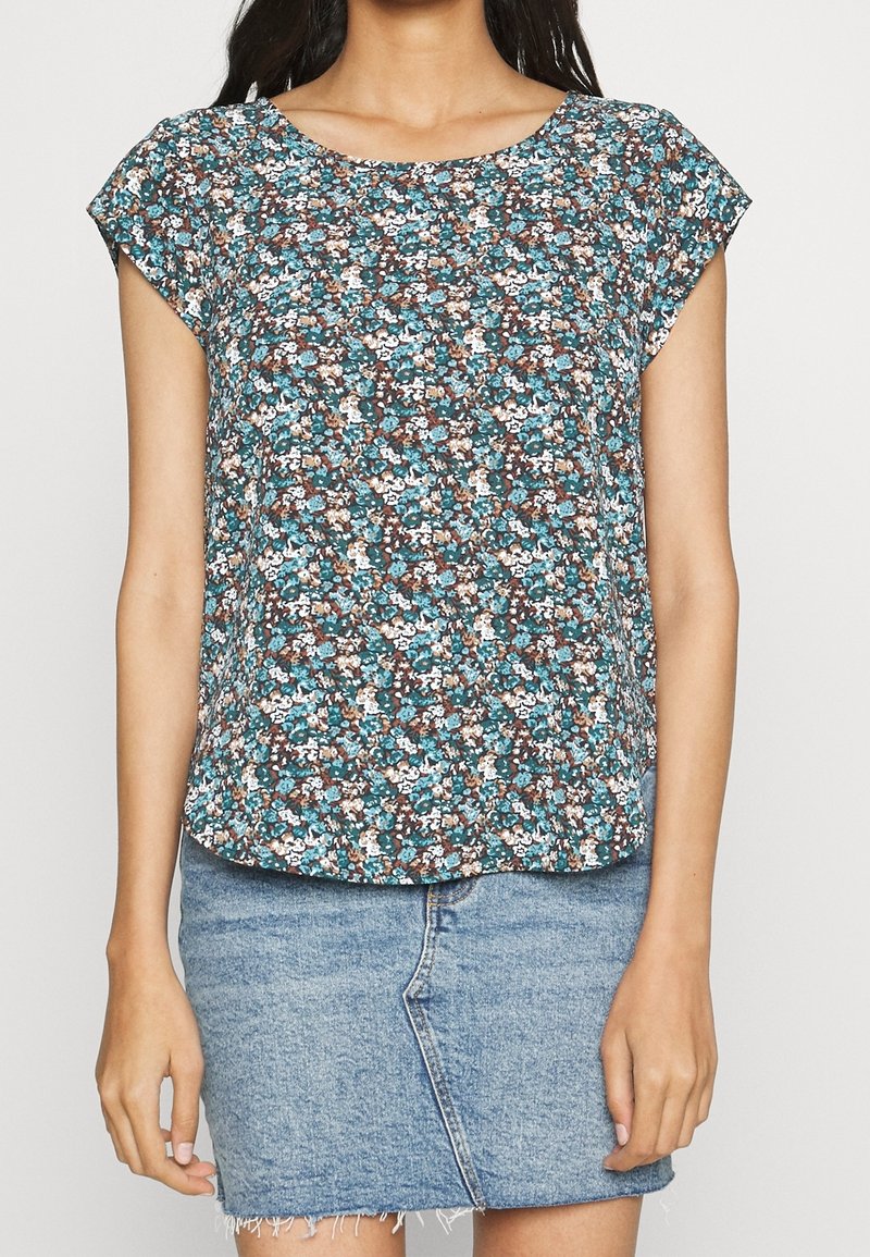 Haut floral à manches courtes avec un col rond ; présente un motif turquoise, marron et crème sur un fond sombre ; tissu léger.