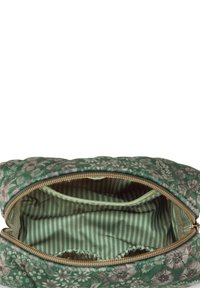 Green floral-patterned bag with a quilted exterior. Gold zipper, striped green interior lining, and inner pockets for organization.