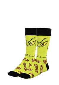 Calze gialle con un design del Grinch, con accenti neri in cima e sulle punte. Il tessuto è morbido e presenta il testo ripetuto "Grinch".