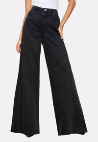 LUCY MECKLENBURGH - Flared-farkut - washed black