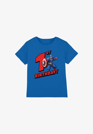 Blue short-sleeve t-shirt featuring a cartoon character and text reading "1st BIRTHDAY!" in bold red and black. Cotton material, casual fit.