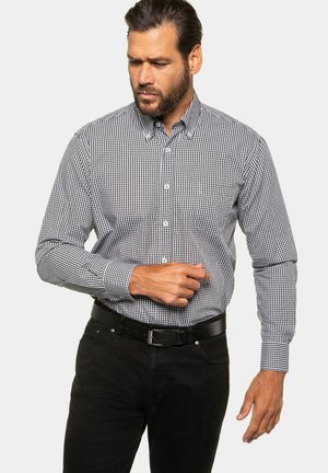 Men's button-up shirt made of black and white gingham check fabric, long sleeves, button-down collar, paired with a black belt and dark jeans.