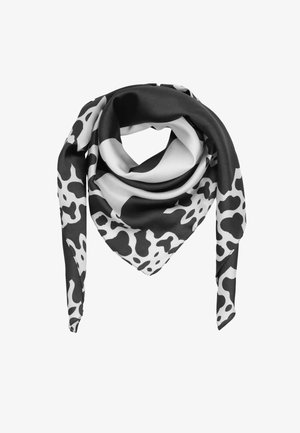 Schwarz-weißes Seidentuch, das in einer dreieckigen Form gefaltet ist, mit unregelmäßigem Kuhfleckenmuster auf weißem Hintergrund.