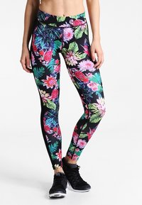 Leggings à motif tropical en noir, ornées de fleurs roses et vertes éclatantes, de feuilles de palmier et d'une taille haute. Fabriqués en matériau extensible.