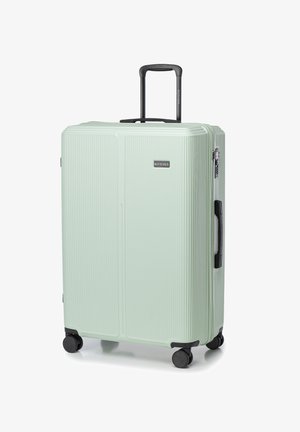 Light green suitcase with ribbed texture, retractable black handle, and four black wheels for mobility. Features logo on front.