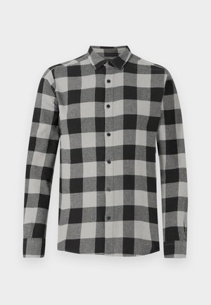 Chemise à manches longues à carreaux noirs et gris avec une fermeture à boutons sur le devant. Dotée d'un col et de boutons noirs. Fabriquée en tissu doux et texturé.