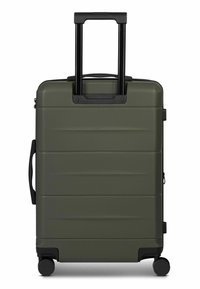 Valigia rigida di colore verde oliva con superficie strutturata, dotata di manico nero retrattile, quattro ruote e maniglia laterale per il trasporto.