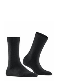 Chaussettes noires avec un motif texturé composé de petits points, une bordure côtelée et un talon et un orteil renforcés, fabriquées à partir d'un matériau doux et extensible.