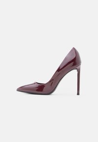 Burgundy patent leather high heel shoe with a pointed toe and a sleek design; features a stiletto heel and smooth, shiny texture.