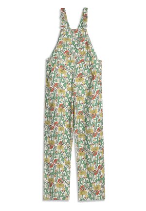 Mono blanco de pierna ancha, con tirantes ajustables y un estampado colorido de flores y follaje en tonos verdes, amarillos y rojos.