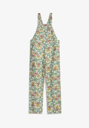 Salopette blanche à jambes larges, bretelles ajustables, avec un imprimé floral et feuillage coloré en tons verts, jaunes et rouges.