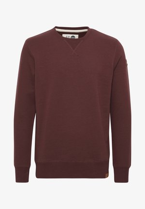 Bordo spalvota megztinis ilgomis rankovėmis, apvaliu iškirpimu, su giliomis rankogaliais ir apatine dalimi, pagamintas iš minkštos medžiagos, su maža prekinio ženklo etikete šone.