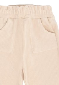 Beige corduroy broek met een elastische tailleband, voorzien van twee voorzakken en een gestructureerd ribbeloppervlak.