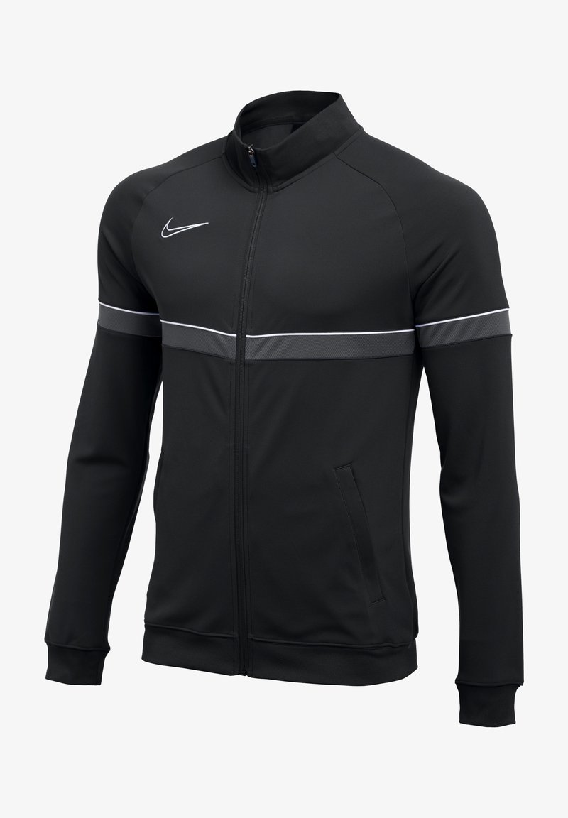 Veste Nike noire à fermeture éclair complète avec manches longues, une bande blanche sur la poitrine et les manches, un logo Nike blanc sur le côté droit de la poitrine.