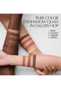 Four arm swatches of eyeshadow in varying skin tones display neutral colors: light beige, tan, warm brown, and dark chocolate.