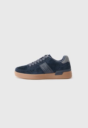 Navy blue suede sneaker with grey laces, "BORG" logo on the side, and light brown rubber sole on a white background.