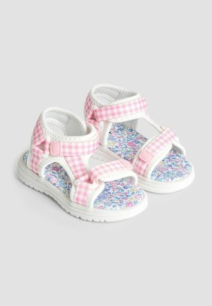 Rožu un baltu pārbaudi sandales ar Velcro siksnām, ar ziedu raksta iekšzoli un teksturētām gumijas zālēm.