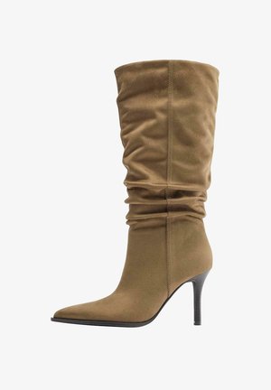 Tan suede mid-calf slouch boot with pointed toe and thin black high heel.