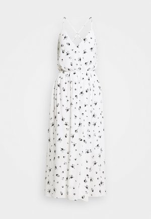 Vestido maxi blanco sin mangas con estampado floral negro, escote en V, tirantes cruzados y cintura fruncida.