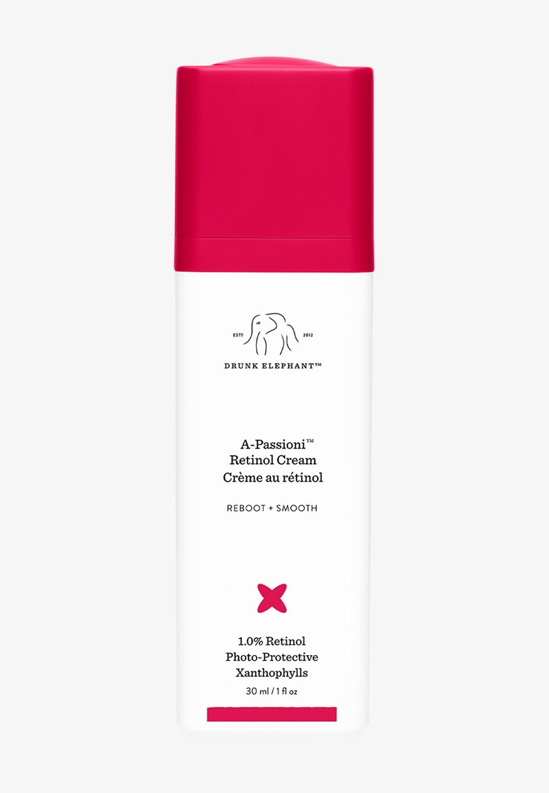 White bottle with a hot pink cap, featuring black text. Contains retinol cream, 30 ml. Smooth surface with minimalistic design.