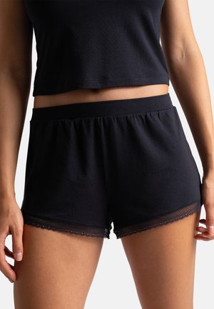 Shorts en mélange de coton bleu marine avec une taille élastique et une délicate finition en dentelle au bas, offrant une coupe ample pour le confort.