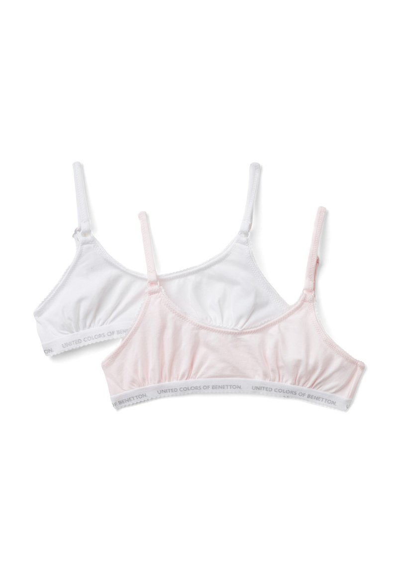 Dos sujetadores en blanco y rosa claro. Tejido de algodón suave, tirantes ajustables y bandas elásticas con el logotipo de "United Colors of Benetton".