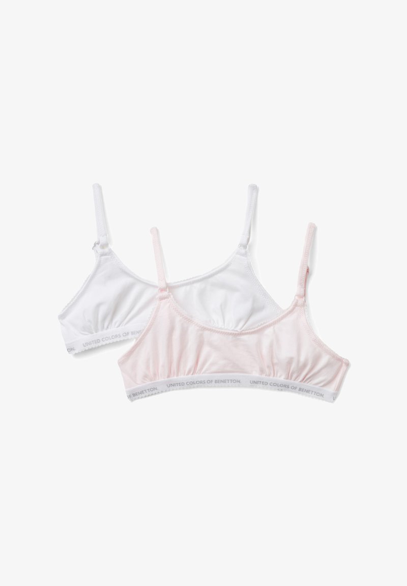Dvě krajkové podprsenky v bílé a světle růžové barvě. Měkká bavlněná tkanina, nastavitelné ramínka a elastické pásky s logem "United Colors of Benetton".