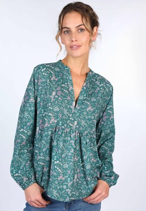 Bluse mit floralem Muster aus teal-farbenem Stoff, mit V-Ausschnitt, langen Puffärmeln und gerafftem Detail an der Taille.