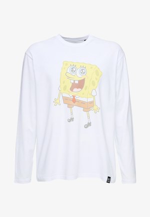 Valkoinen pitkähiha T-paita, jossa on suuri, värikäs grafiikka sarjakuvahahmosta, jolla on neliön muotoinen vartalo, pyöreät silmät ja ruskea solmio.