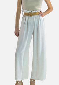 Hvide bukser med vide ben i tekstureret stof, med elastik i taljen og et flettet tanfarvet bælte med rund spænde.