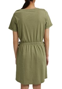 Robe à manches courtes, verte olive, avec une coupe décontractée et une taille smockée, fabriquée dans un tissu léger au toucher doux.