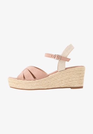 Wedge sandal with a soft pink suede upper, open toe design, and an adjustable ankle strap. Features a braided jute wedge heel for texture.