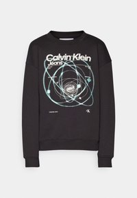 Černá mikina s grafikou stylizovaných orbit a textem "Calvin Klein Jeans" v bílé a světle modré barvě. Žebrované manžety a spodní lem.