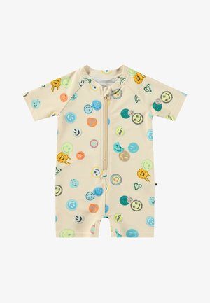 Kortermet beige baby romper med glidelås foran, med fargerike sirkulære smilende ansiktsmønstre i ulike nyanser av blått, grønt og oransje.
