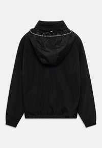 Black windbreaker jacket with a matte finish, featuring a dual-textured hood, elastic cuffs, and a white logo band along the neckline.