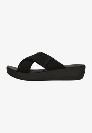 Black flip-flop sandal with woven fabric straps, platform sole, and curved design. Features a textured strap for added grip.