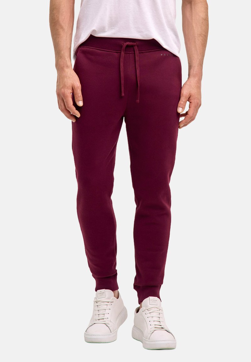 Bordeauxfarbene Jogginghose aus Baumwollmischung mit einem elastischen Bund und Kordelzug, gerippten Bündchen und glatter Textur. Weiße Sneakers sind im Lieferumfang enthalten.