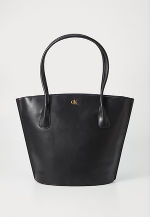 Black leather tote bag with two rounded handles, smooth texture, and a gold logo accent on the front. Open top design with no closure.