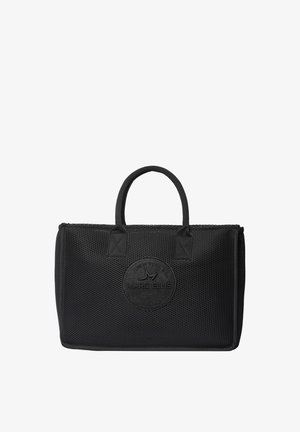Sac cabas noir Marc Ellis avec surface texturée et deux petites poignées, arborant un logo rond embossé sur le devant.
