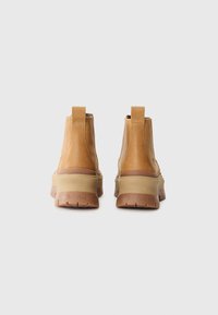 Brown leather ankle boots with a smooth finish, elastic side panels, and a rubber sole. Logo visible on the back heel.