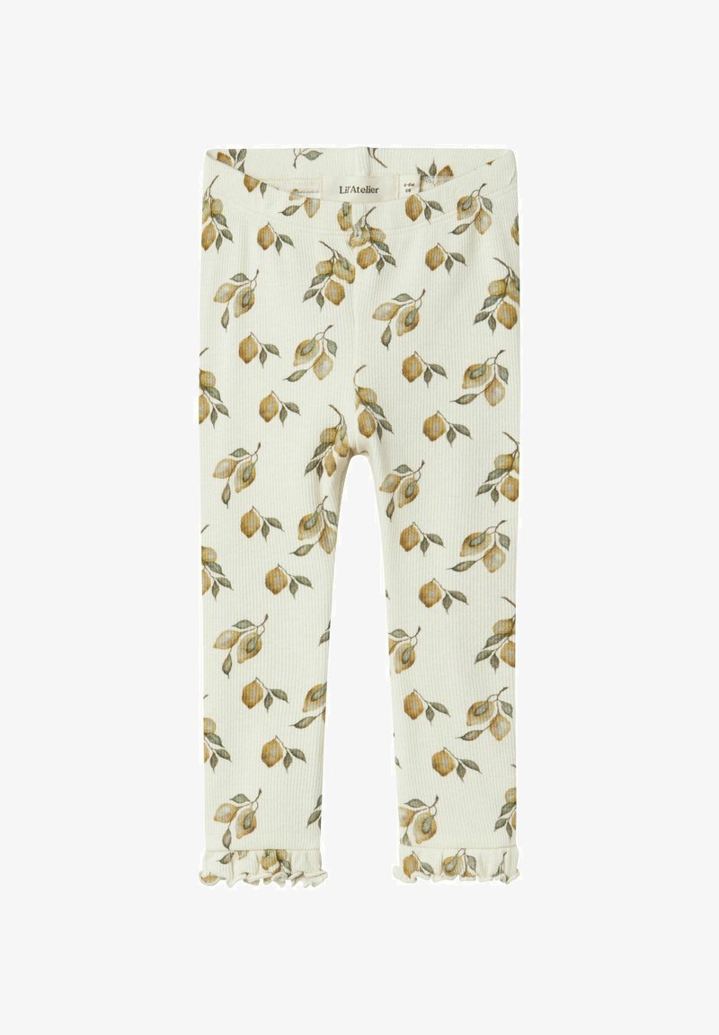 Rurkowane legginsy w kolorze kremowym z kwiatowym wzorem w odcieniach żółtego i zielonego, z falbaną na dole. Miękki materiał z elastycznym pasem.