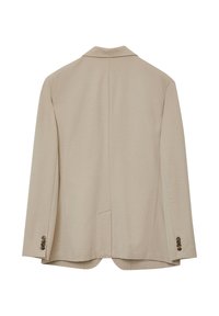 Blazer beige con un tessuto texture, spacco singolo sul retro, polsini a due bottoni e design con rever a punta.