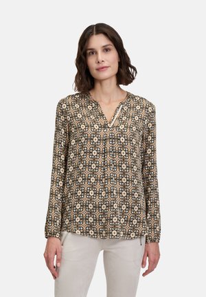 Langärmlige Bluse mit einem schwarz-beigen Blumenmuster, V-Ausschnitt und gerafften Details an den Schultern. Weiche Stofftextur.