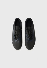 Black athletic shoes with a textured surface, featuring a lace-up design and navy accents. Nike logo in light blue on the side.