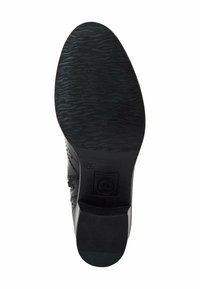 Semelle de chaussure habillée noire avec motif de grip texturé, taille 37 indiquée, et talon empilé bas sur fond blanc.